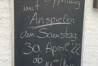 Tafel mit der handgeschriebenen Einladung zur Saisoneröffnung mit Anspielen am Samstag, 30. April